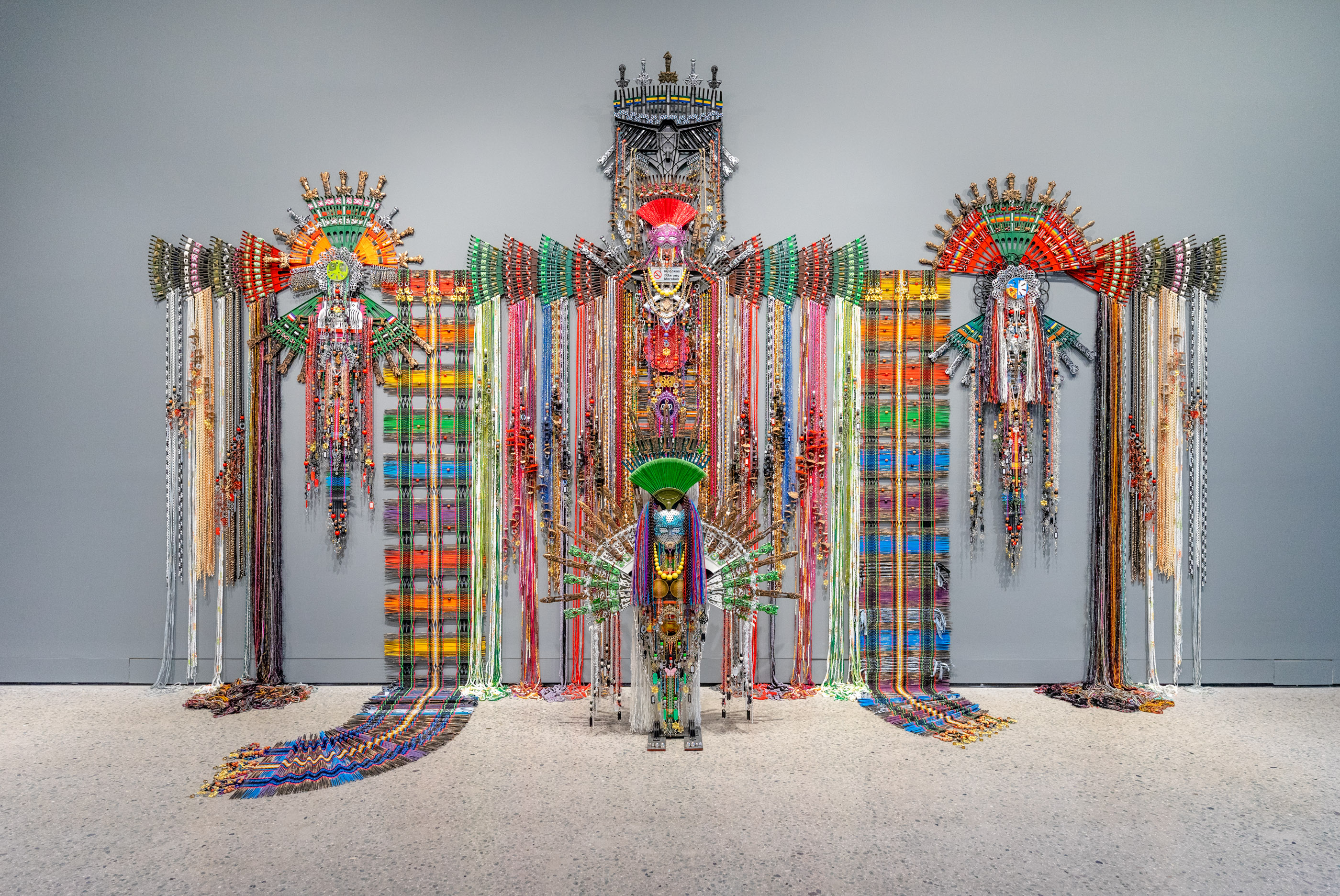 Anne Samat, “Never Walk In Anyone's Shadow”, 2023. Rattan sticks, kitchen and garden utensils, beads, ceramic, metal and plastic ornaments, 365.75 x 731.5 x 25.5 cm. Photo by Brian Holcombe. Courtesy of the Artist and MARC STRAUS.