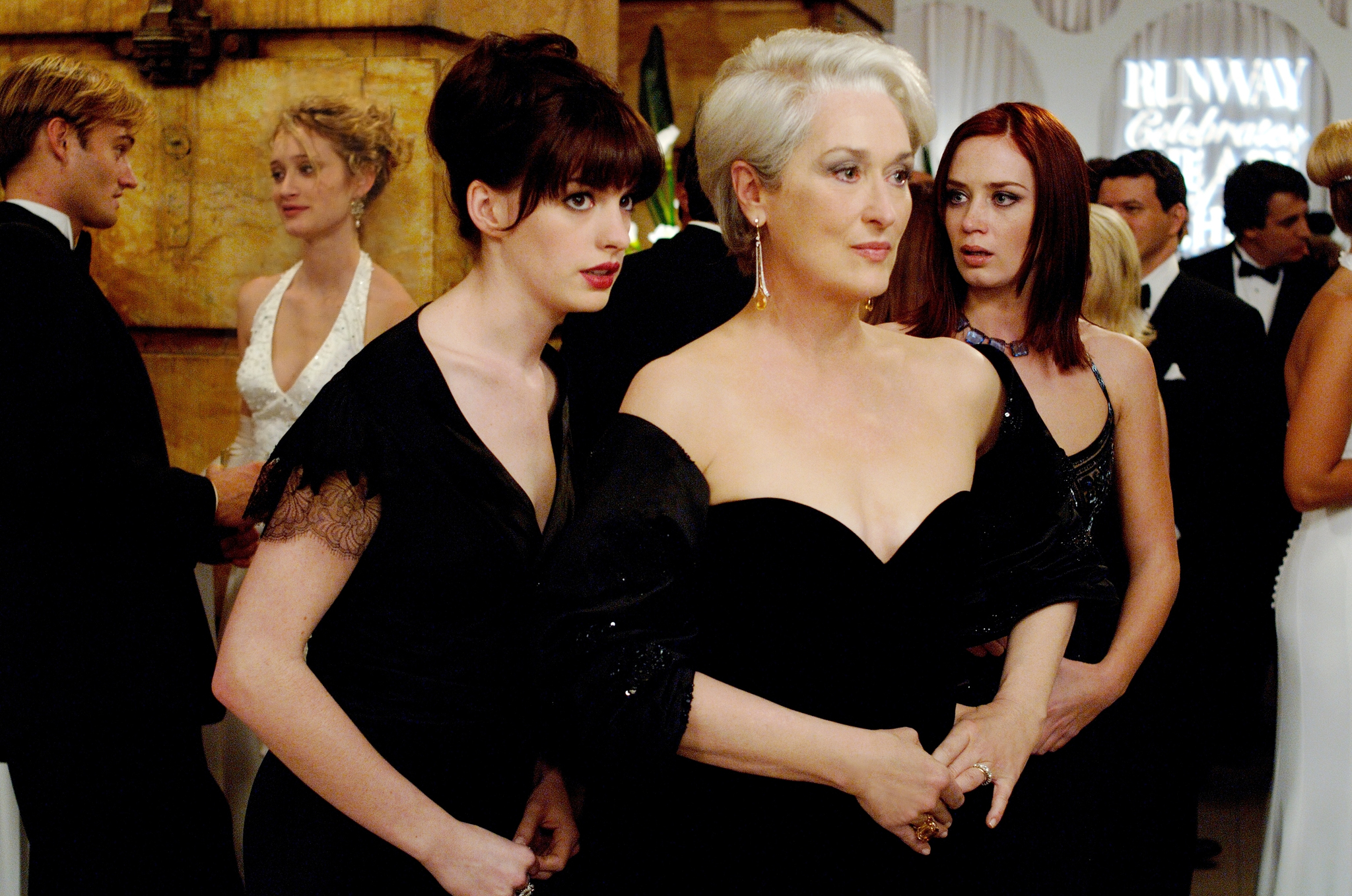Andy (Anne Hathaway, left) whispers some important information to her boss, fashion magazine editor Miranda Priestly (Meryl Streep), as Miranda's first assistant, Emily (Emily Blunt) looks on.
PHOTOGRAPHS TO BE USED SOLELY FOR ADVERTISING, PROMOTION, PUBLICITY OR REVIEWS OF THIS SPECIFIC MOTION PICTURE AND TO REMAIN THE PROPERTY OF THE STUDIO. NOT FOR SALE OR REDISTRIBUTION.